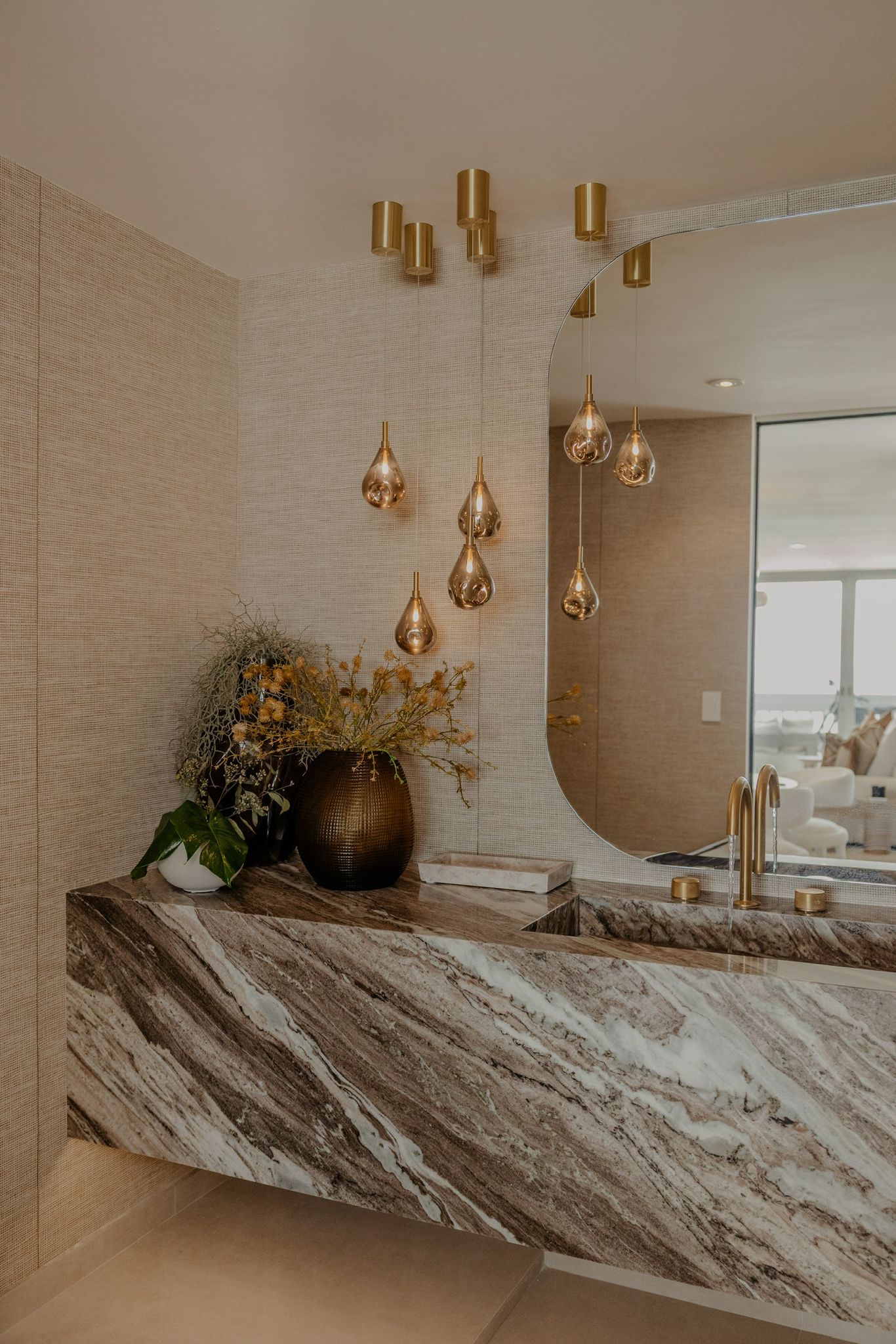 Mirror and brass plates on herringbone wall.